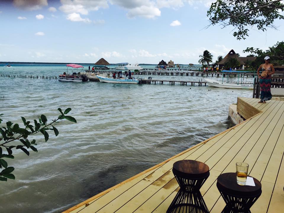 The dock of Bacalar's Lagoon of Seven Colours. In this photo, you can just about make out two different shades of blue in the distance, as the photo is taken from a restaurant overlooking the water.